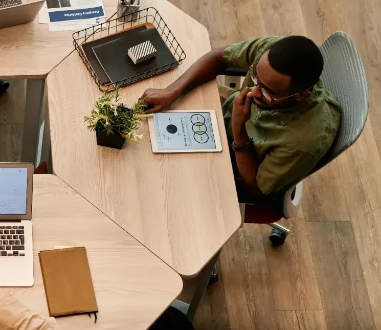 Overhead view of a person working at a desk with a laptop